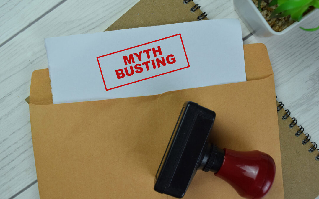 A brown Kraft envelope with a document emerging from top. Document has "Myth Busting" in a rectangular stamp. The stamp lies on top of the envelope.